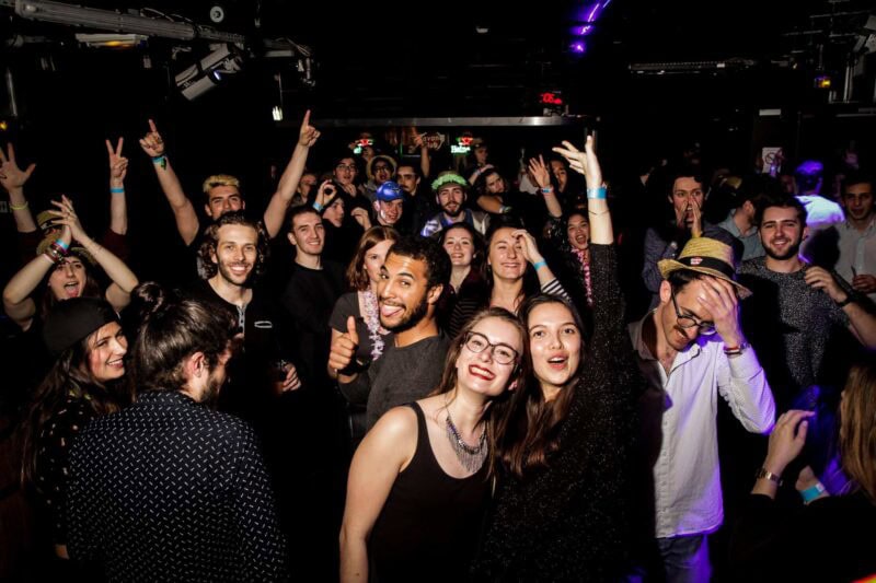 Lively group of young people enjoying a night out at a club in Berlin.