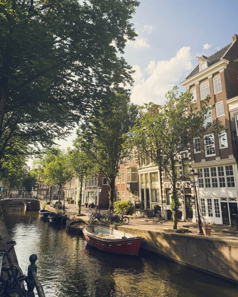 A canal with boats and historic buildings along the waterway in a European city.
