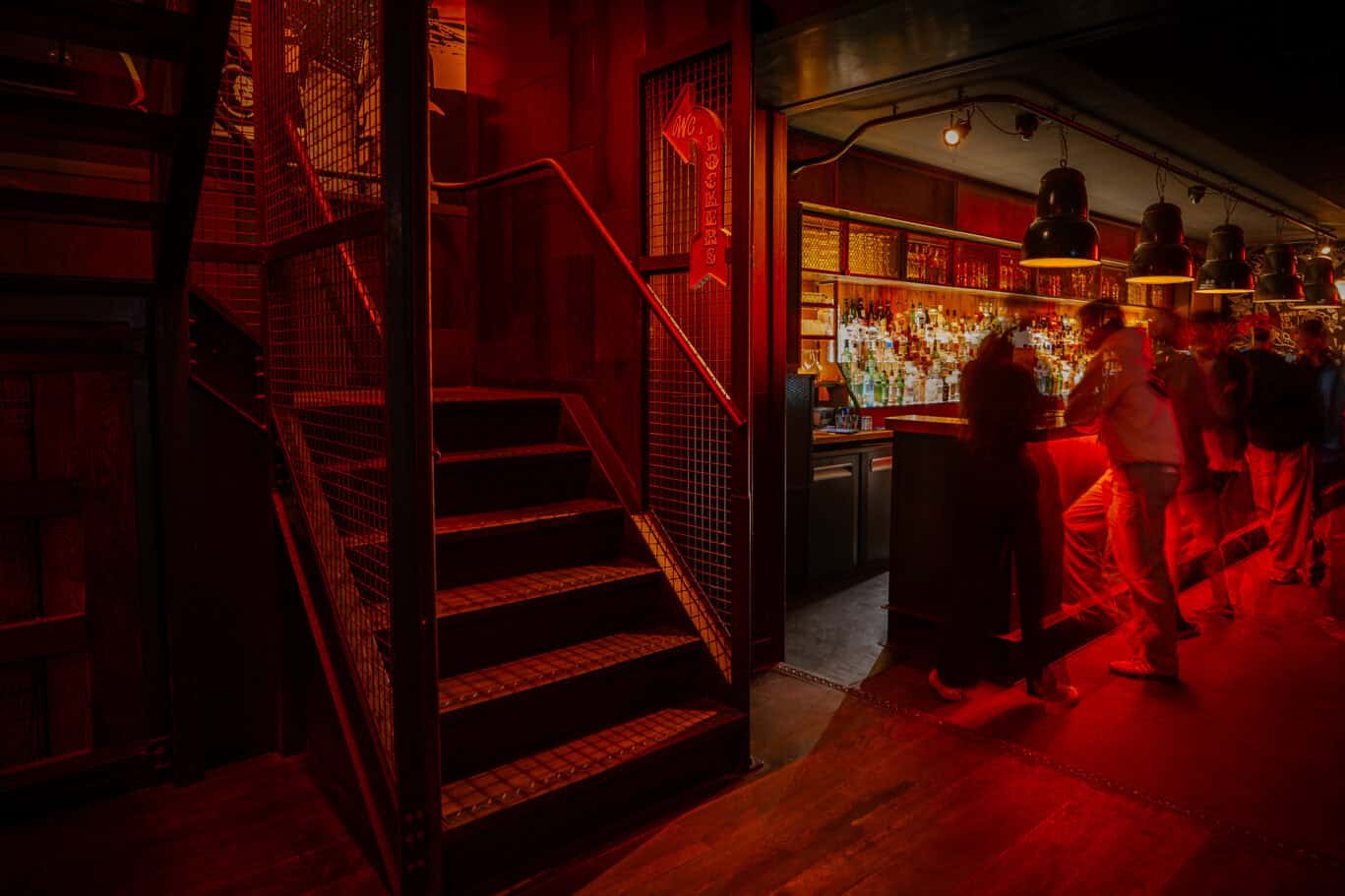 Interior view of Winston Hostel's lively bar area in Amsterdam.