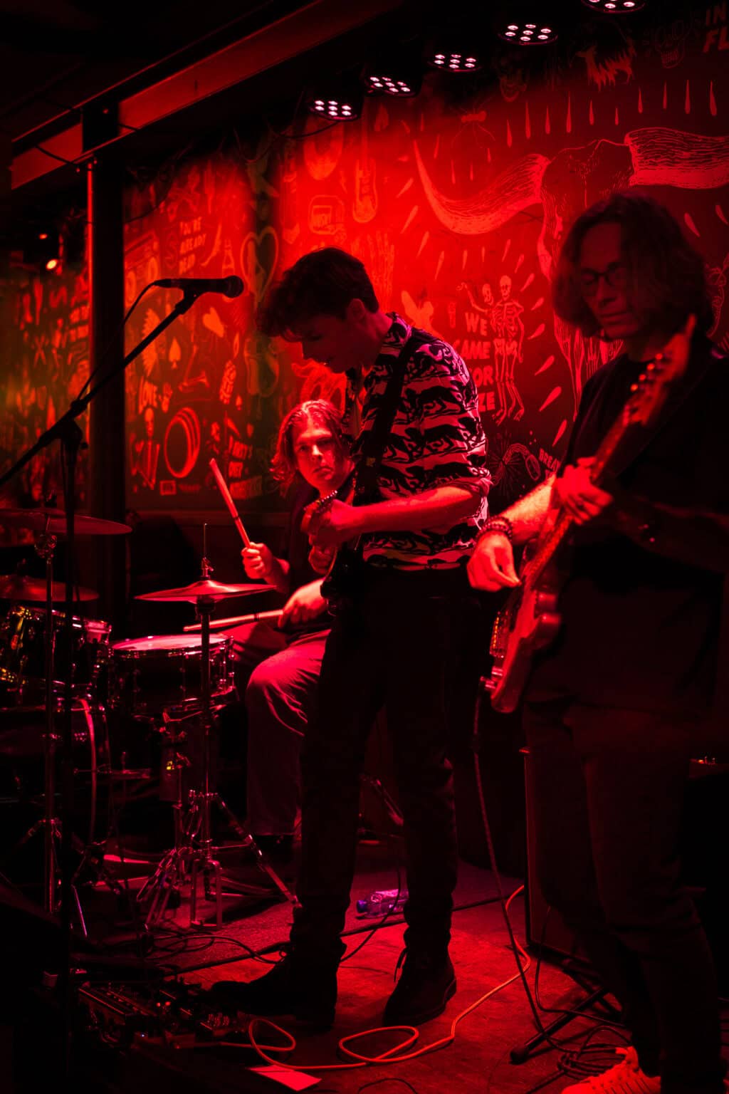 Live band performing on stage at Winston Hostel in Amsterdam with energetic atmosphere.