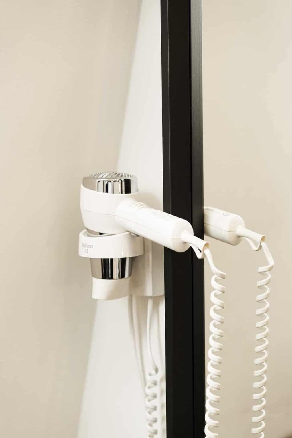 Hairdryer attached to a mirror at Winston Hostel, Amsterdam.