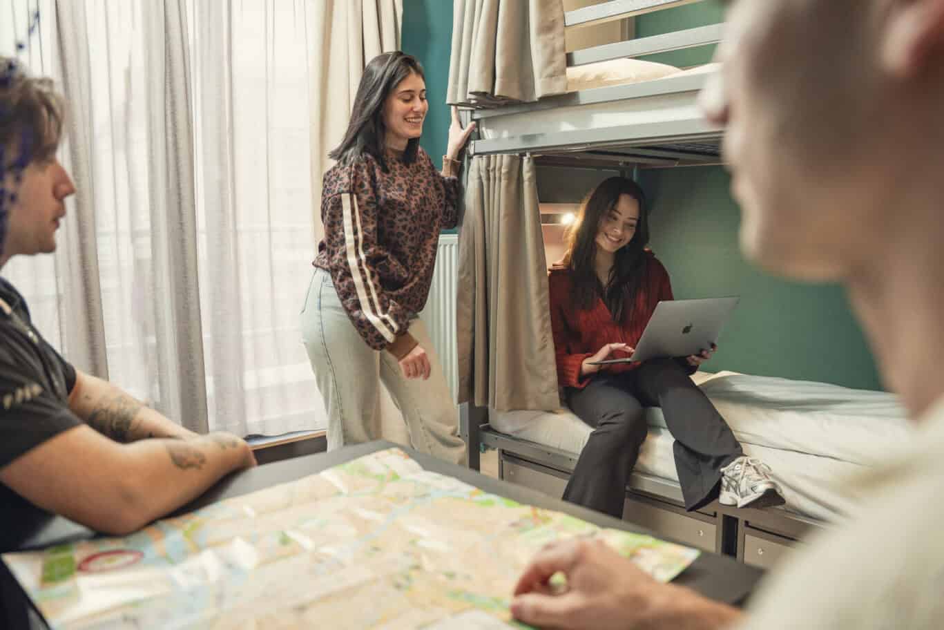 Young travellers enjoying a social dorm room at Winston Hostel, Amsterdam.