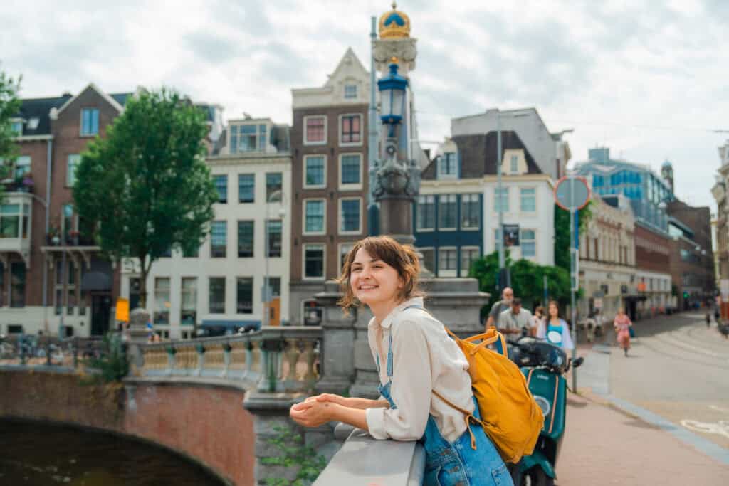 Young woman enjoying Amsterdam city view at Winston Hostel.