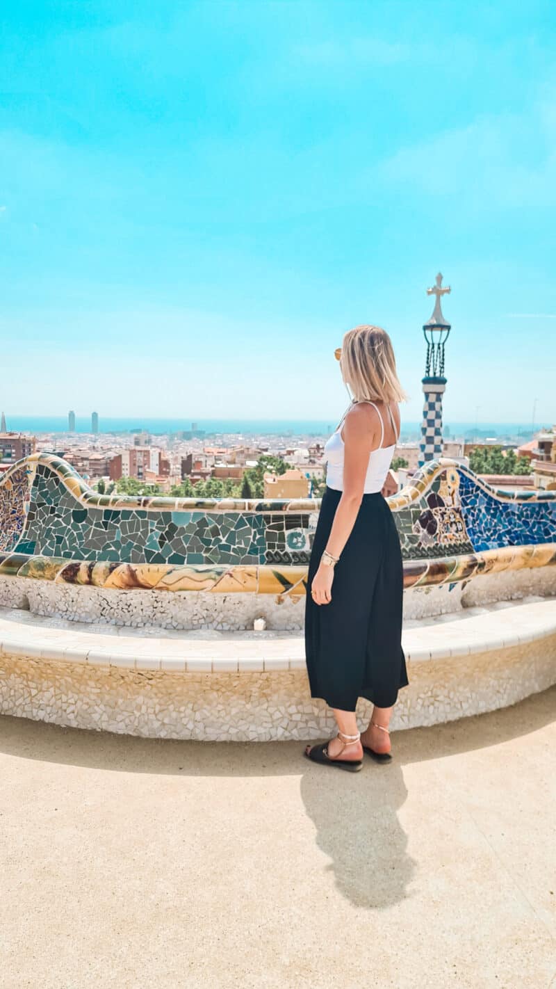 Woman enjoying panoramic view of Barcelona from Park Güell in Mitte Hostel area.
