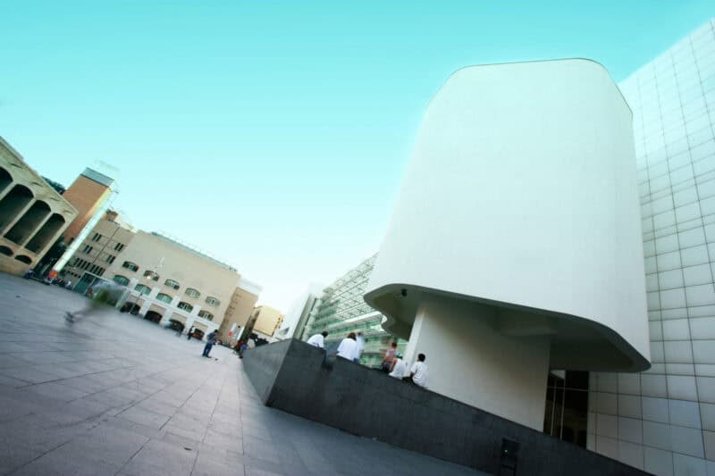 Modern architectural building at Las Ramblas, Barcelona with sleek white design and spacious plaza.