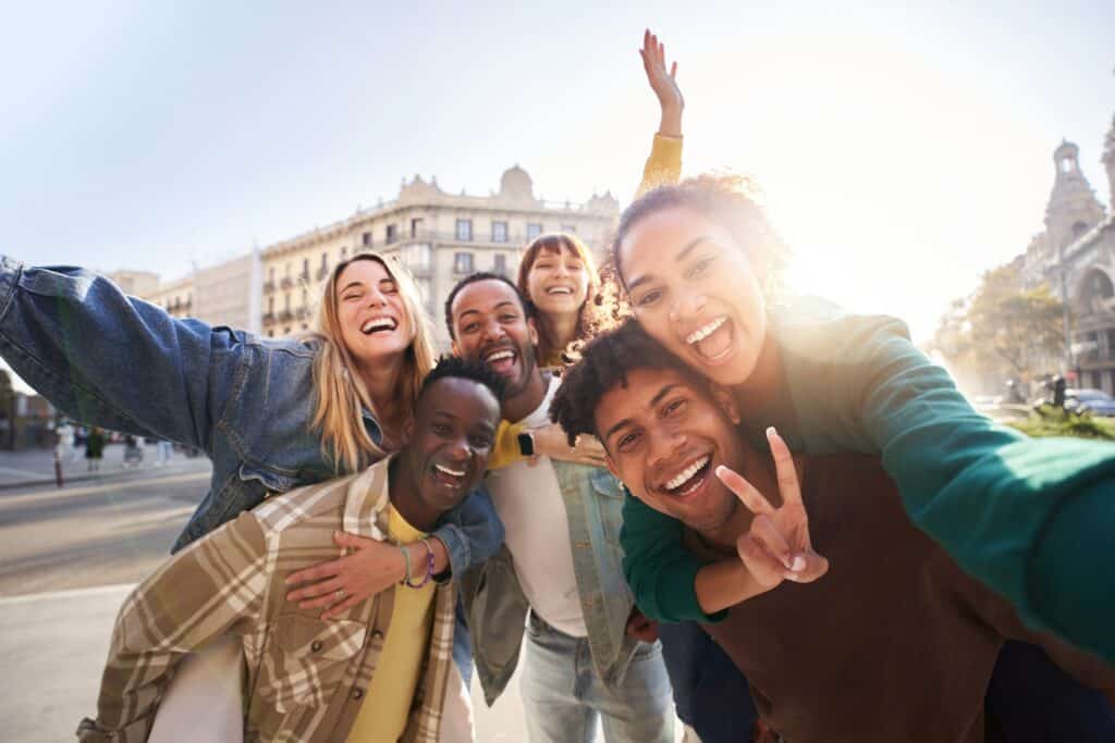 Vibrant group of friends taking a selfie in Berlin’s Alexanderplatz.