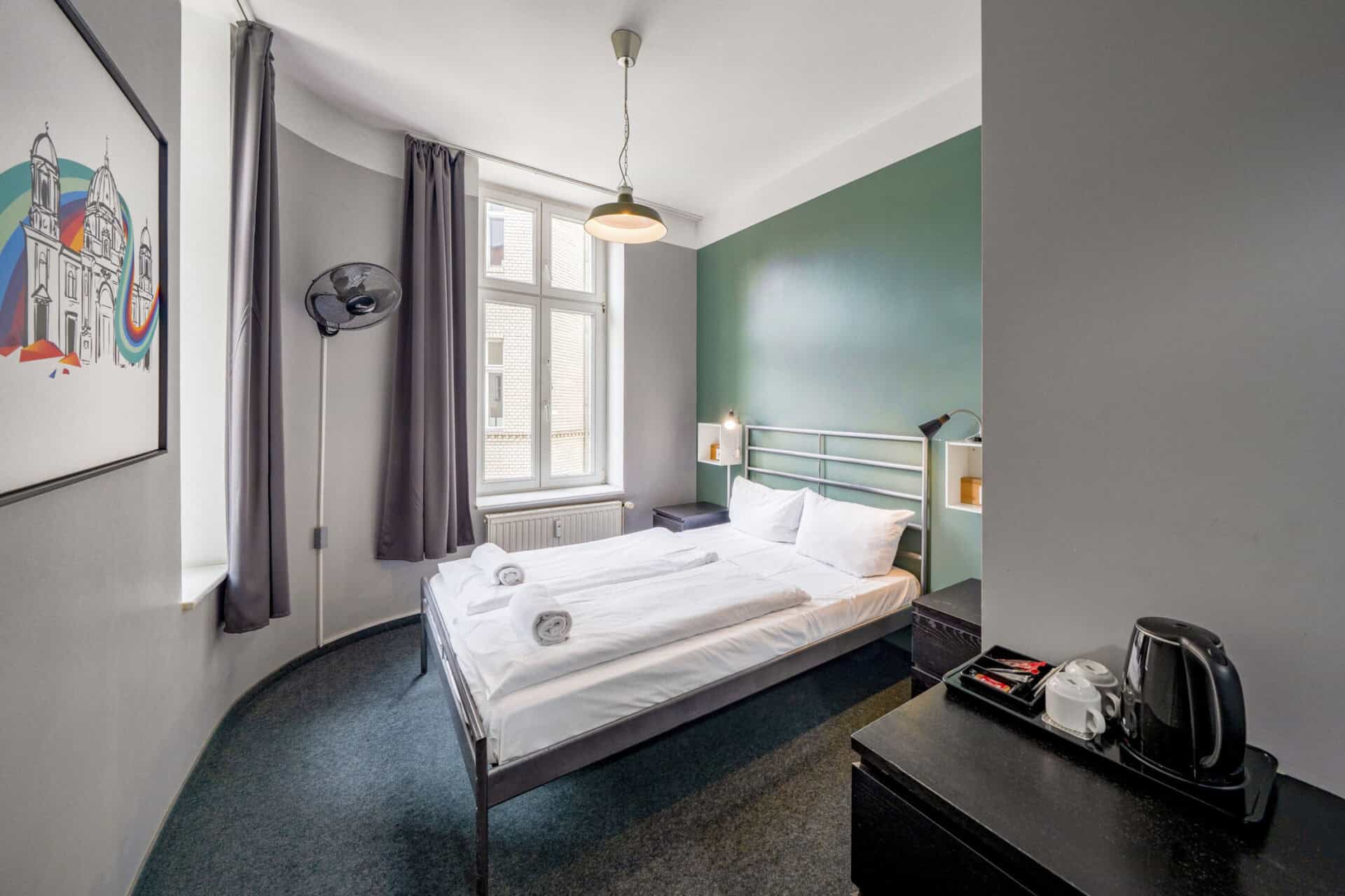 Modern hotel room at St Christopher’s Berlin with a comfortable double bed and colourful decor.