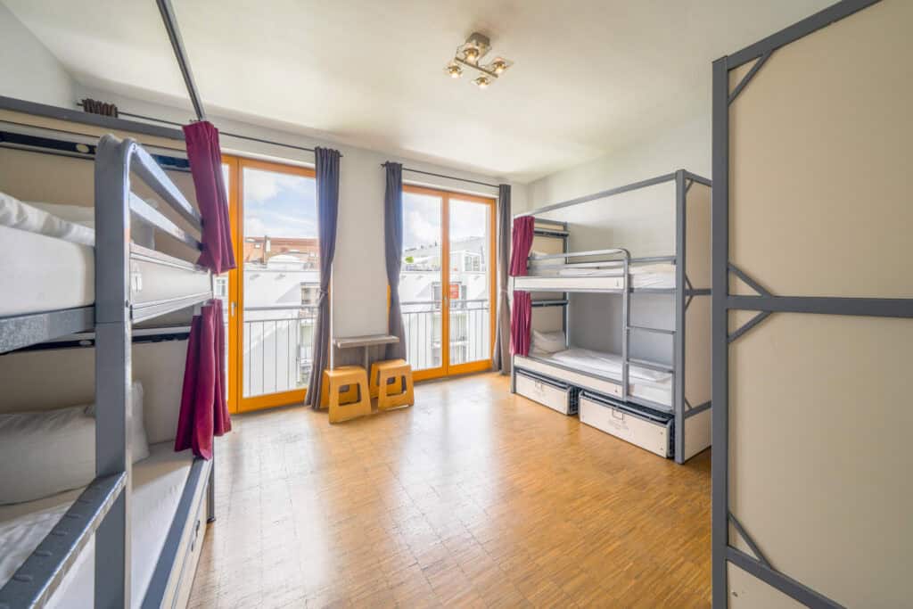 Dormitory room at St Christopher’s Berlin hostel in Mitte, featuring bunk beds and bright natural li.