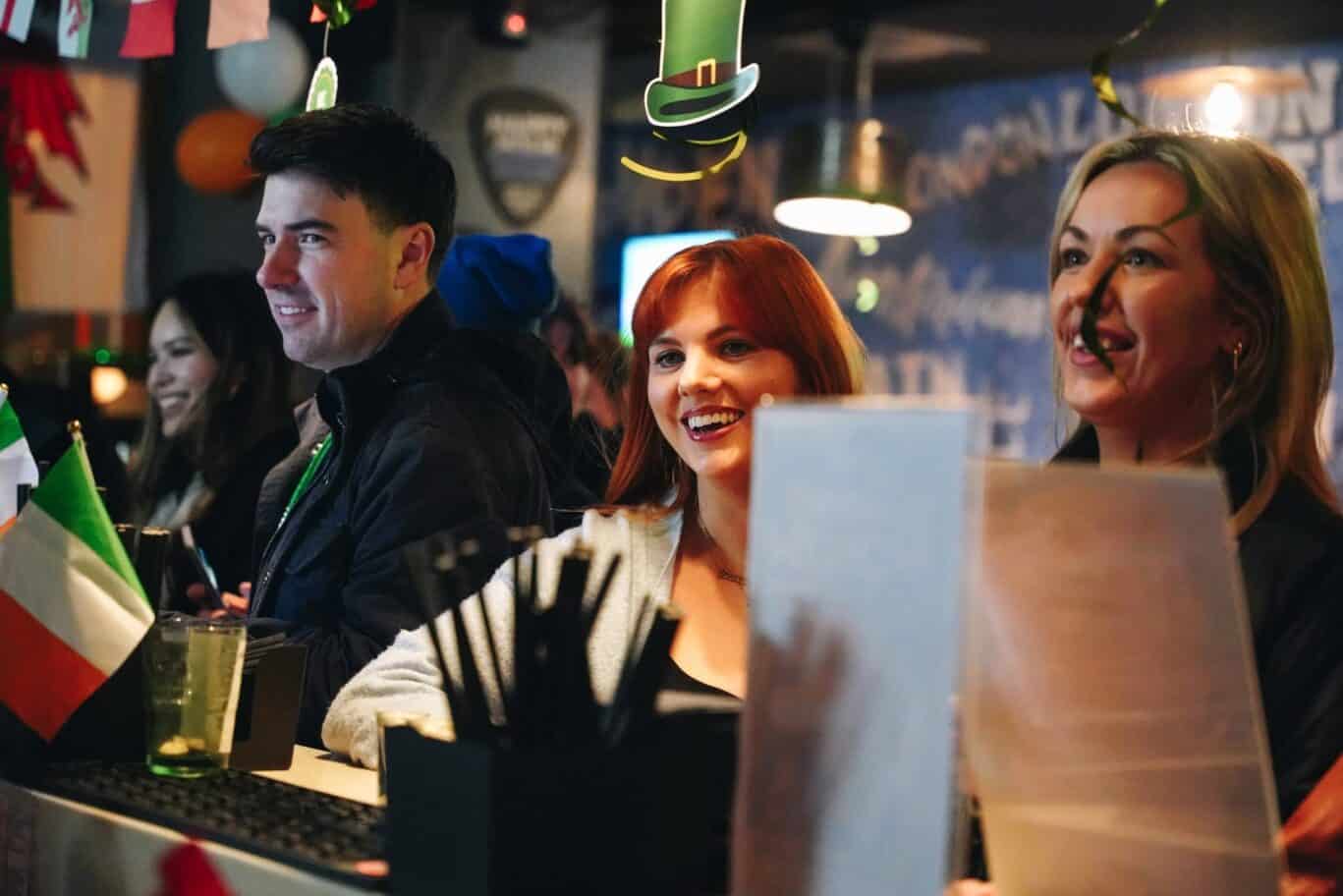 Bright, lively bar scene at St Christopher’s Mitte Hostel, Berlin, with happy guests enjoying drinks.