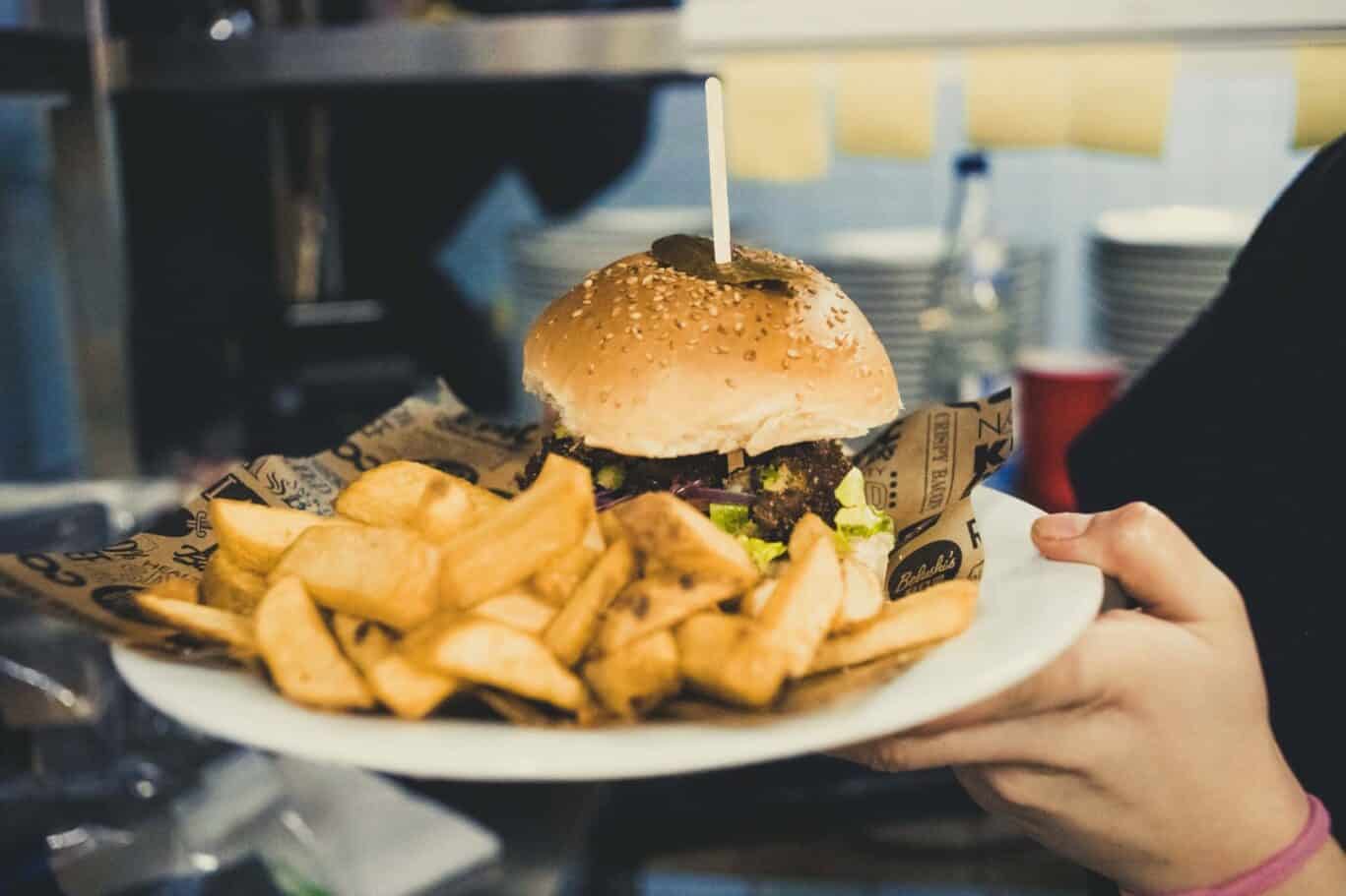 Classic burger with fries served at St Christopher’s Berlin - Mitte hostel. Perfect for travellers s.
