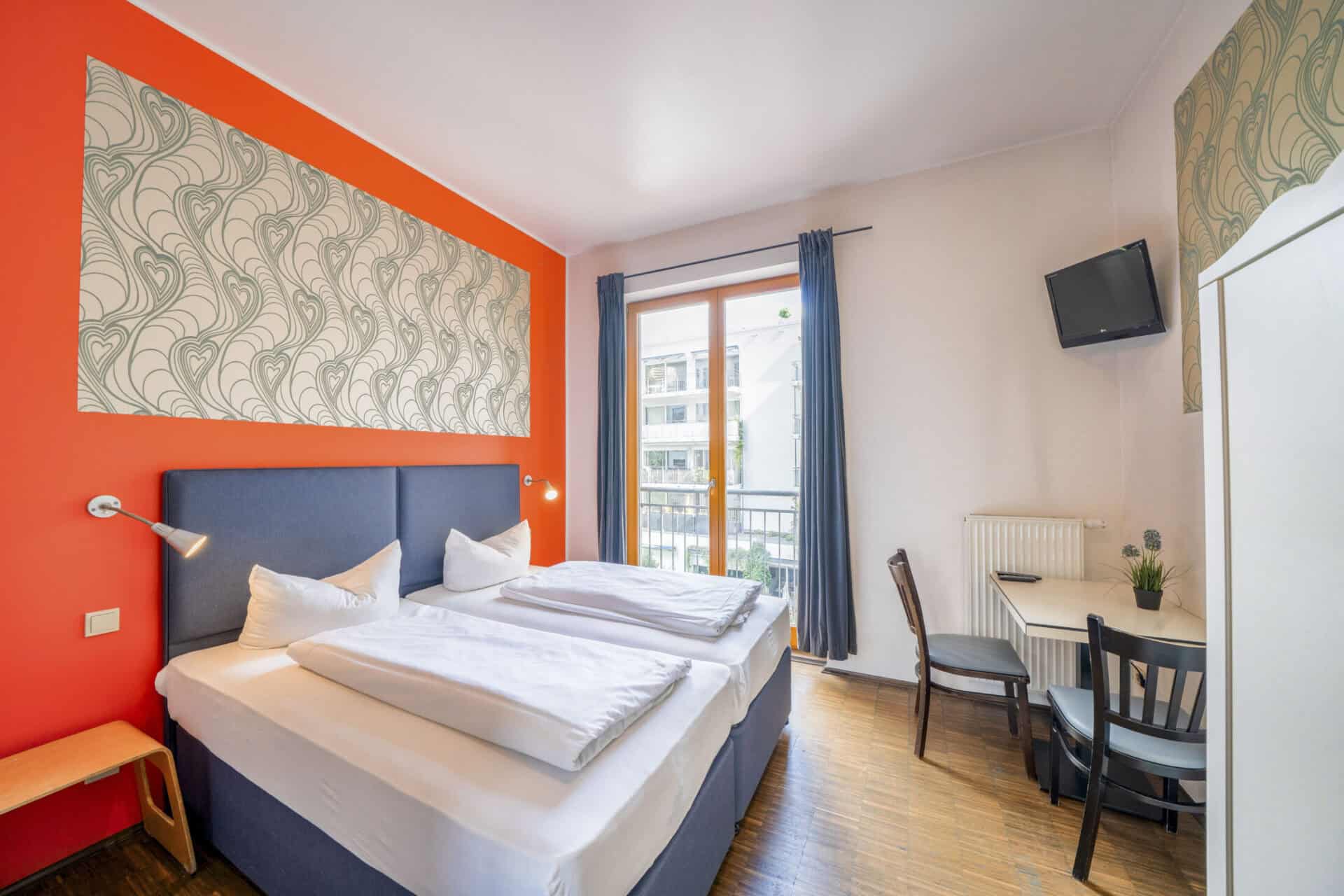Comfortable hostel room at St Christopher’s Berlin - Mitte with vibrant decor and modern amenities.