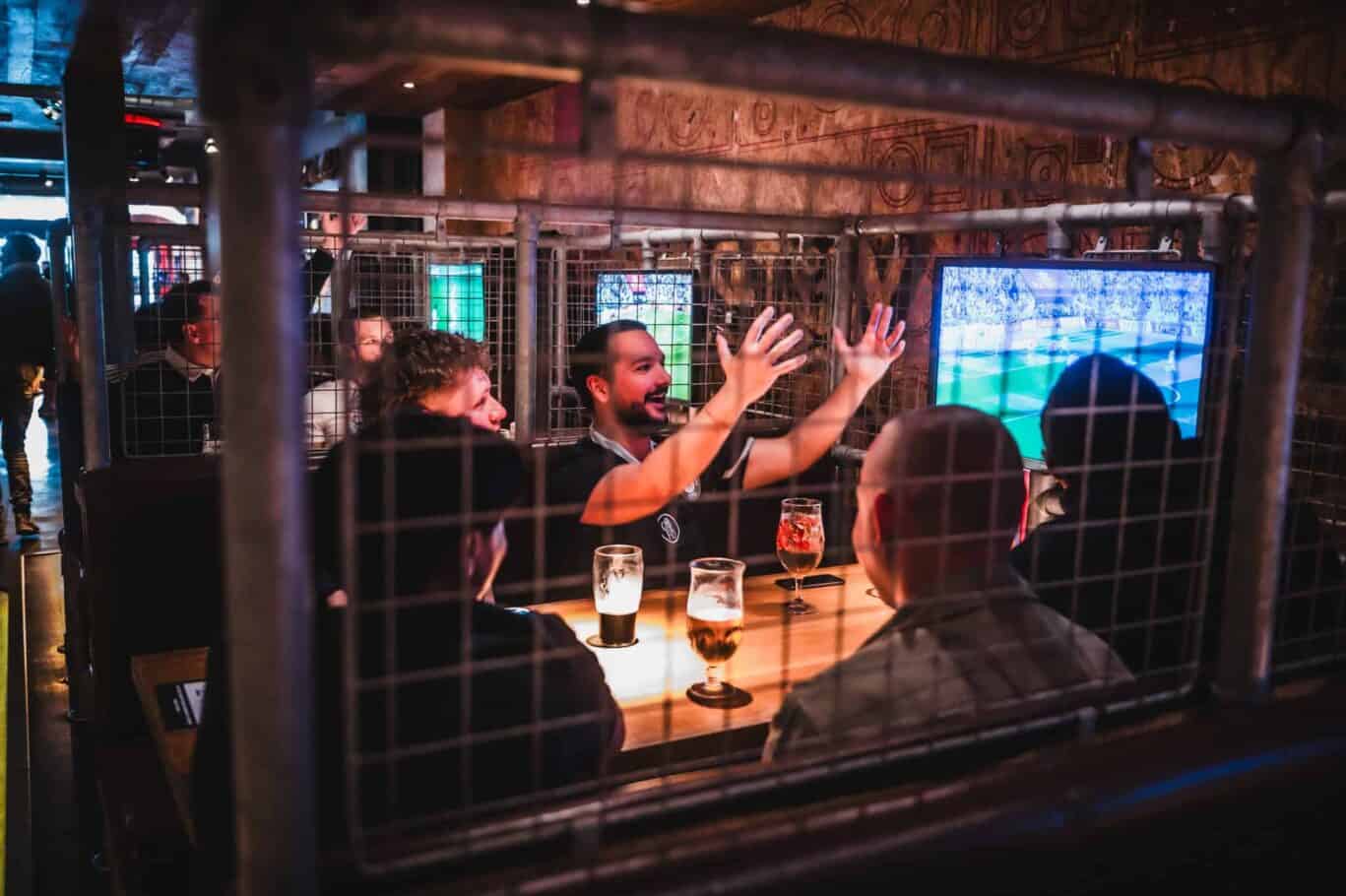 Group of friends enjoying drinks at Mitte Hostel social area in Berlin.