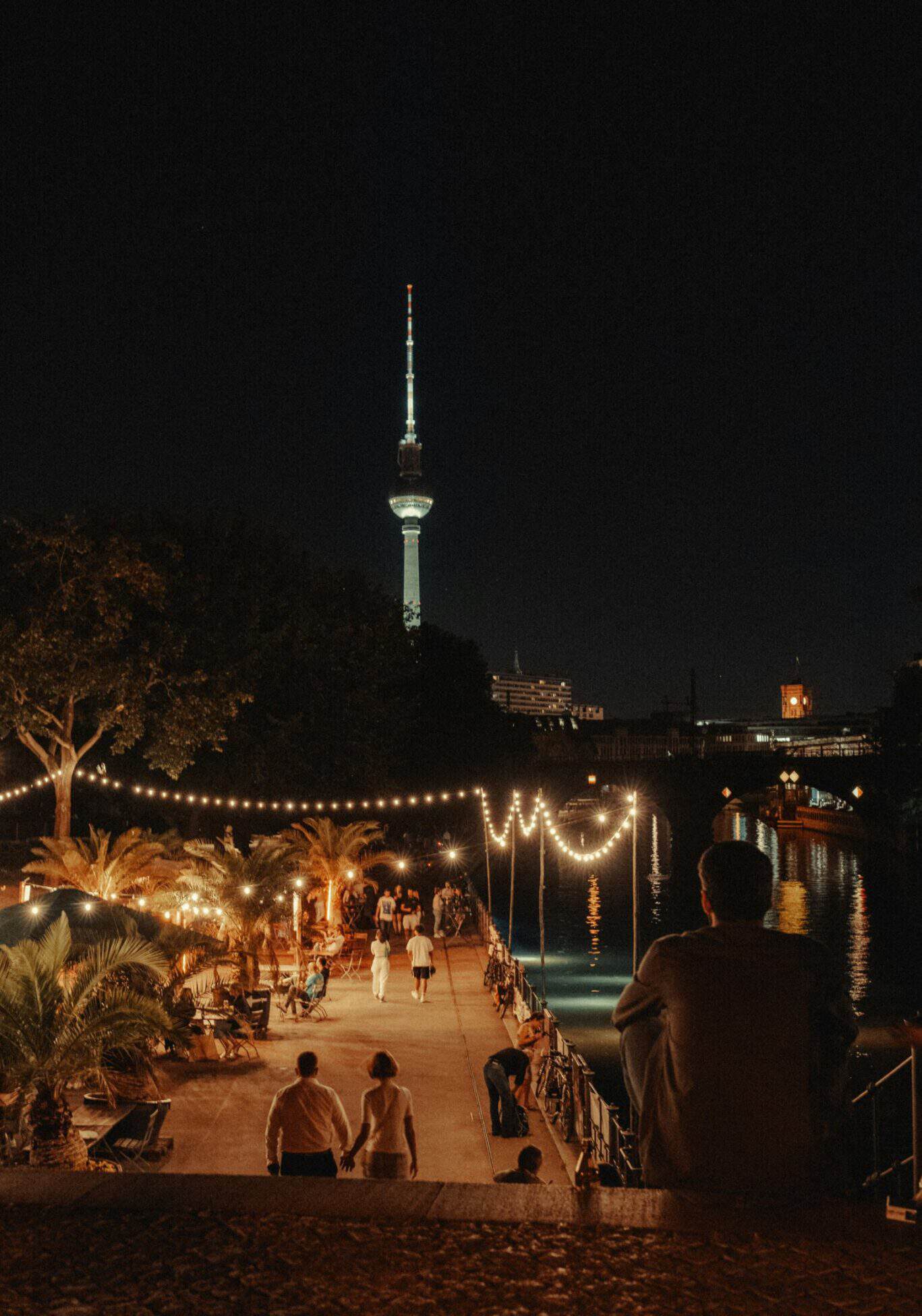 Night view of Berlin Mitte with TV Tower and riverside scene.
