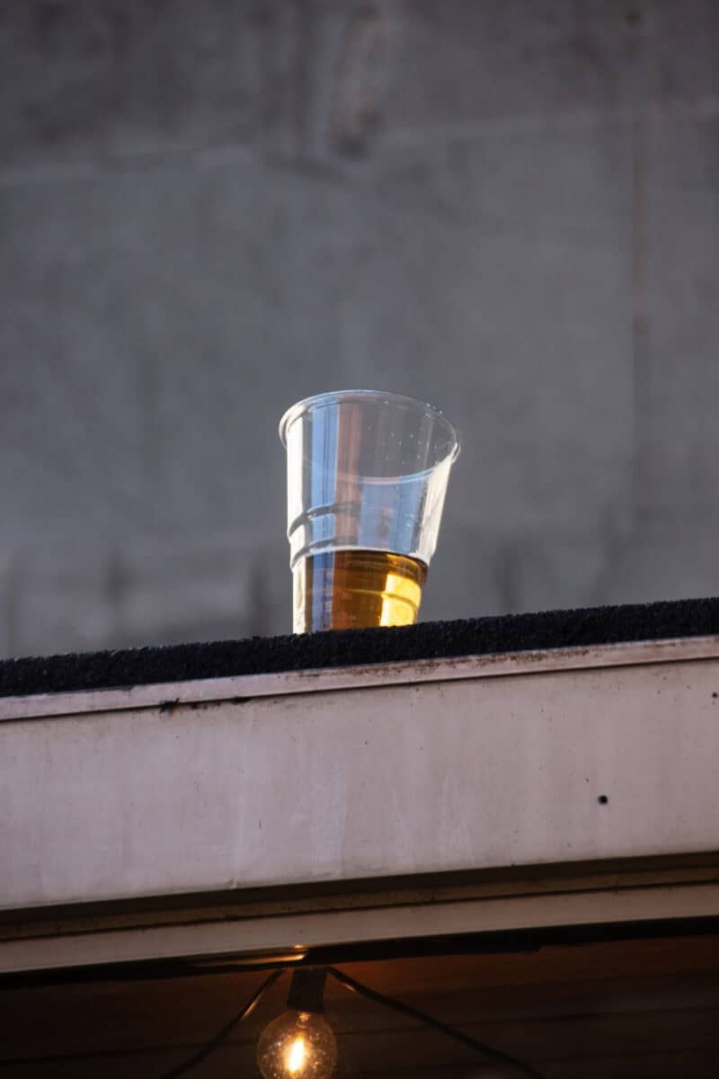 A glass of beer on a ledge at St Christopher's Berlin Mitte hostel, showcasing the social vibe and a.