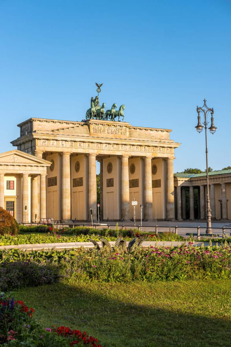Brandenburg Gate, iconic Berlin landmark, with clear blue sky background.