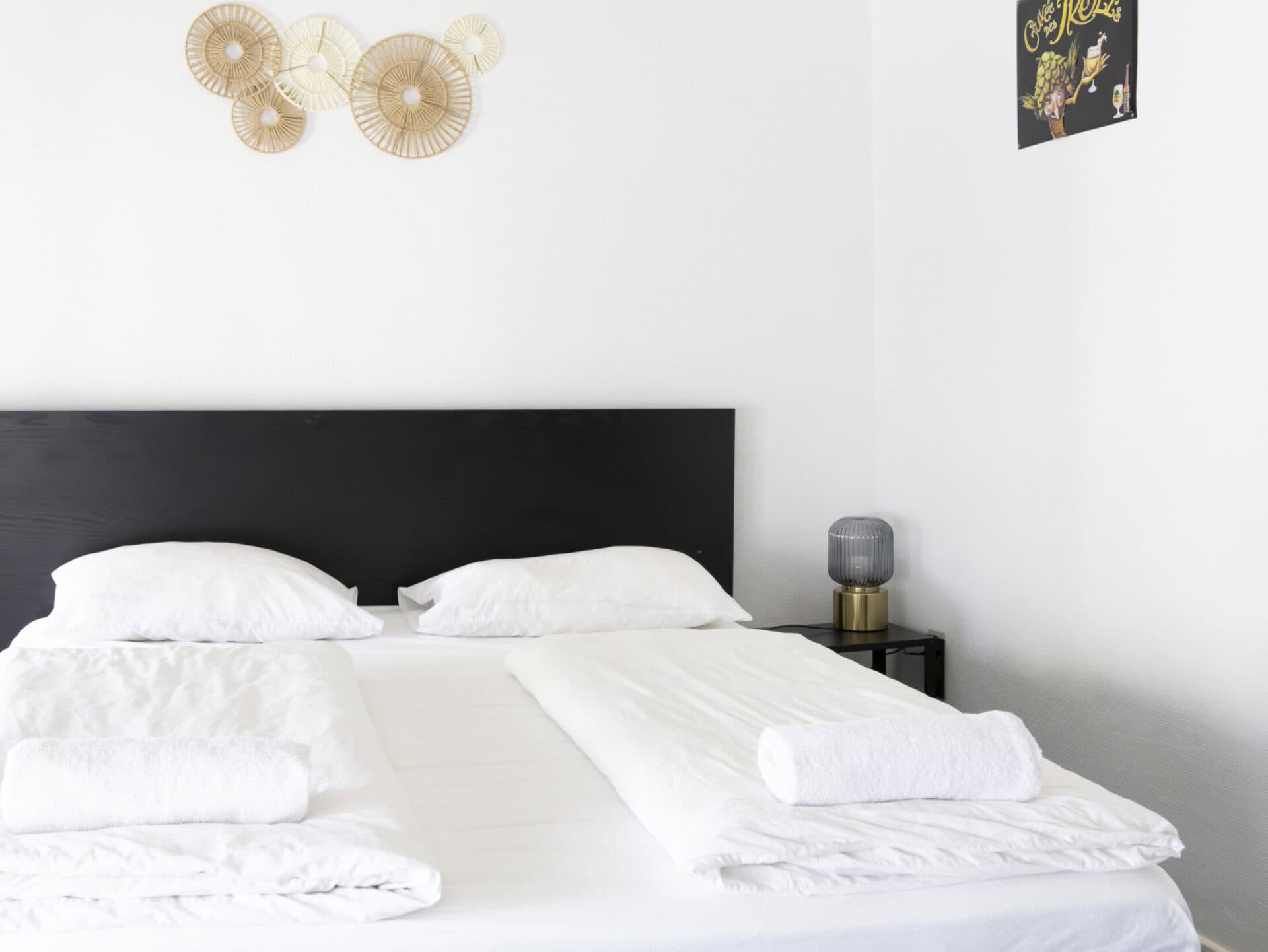 Modern bedroom with white bedding and minimalist decor at St Christopher’s Bruges - The Bauhaus.