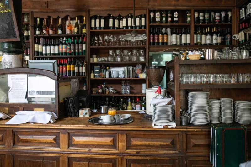 Cozy bar area with wooden shelves stocked with bottles, glasses, and barware at St Christopher’s Bru.
