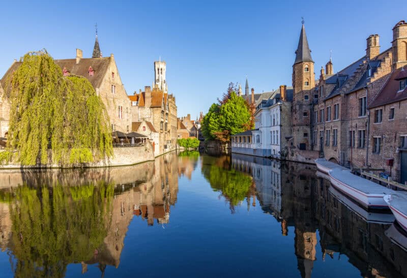 Historic Bruges canal with medieval buildings and boats.