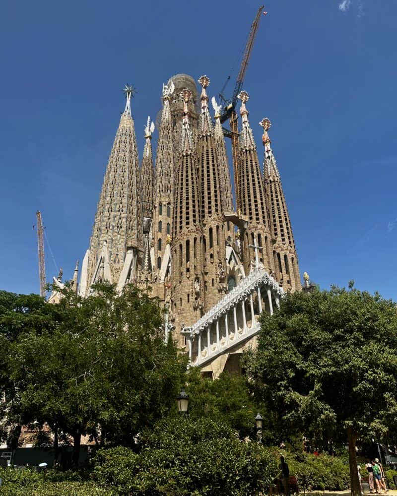 A view of the Sagrada Familia basilica with ongoing construction cranes.