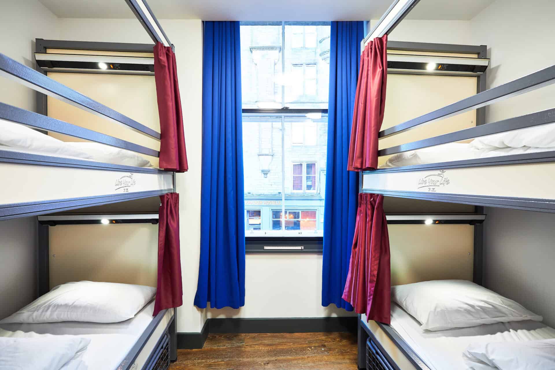 Dormitory room with bunk beds and large window at St Christopher's Edinburgh.