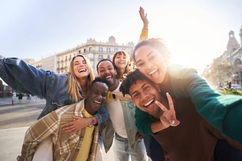 Group of happy young friends taking a selfie in Edinburgh city centre.