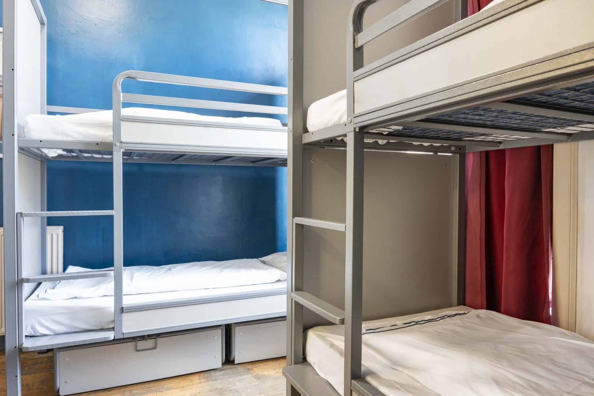 Bunk beds in a hostel dorm room at St Christopher’s Edinburgh, featuring simple, functional furnishi.