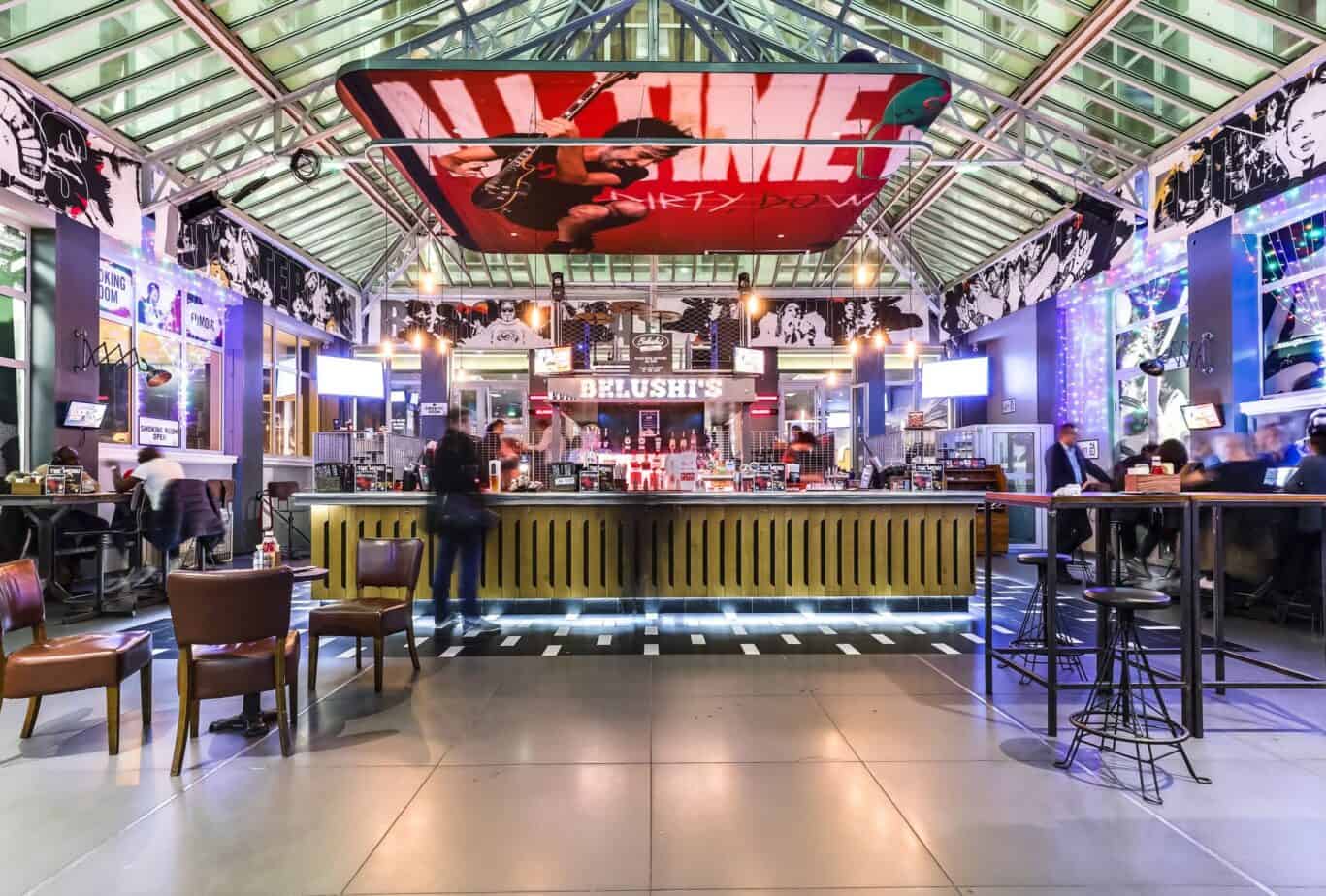 Interior view of the lively bar area at Gare du Nord station, featuring modern decor and vibrant lig.