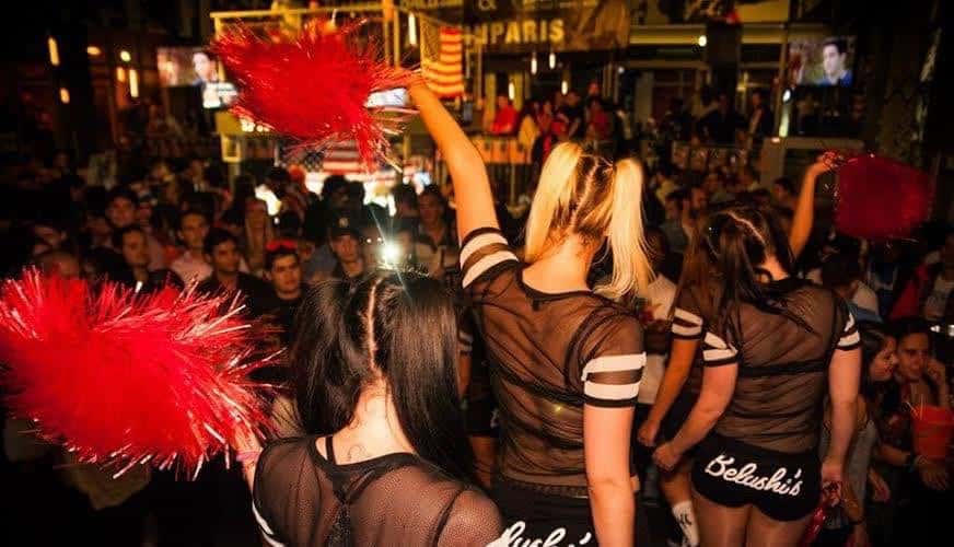 Nightlife at Gare du Nord hostel in Paris with lively crowd and performers.