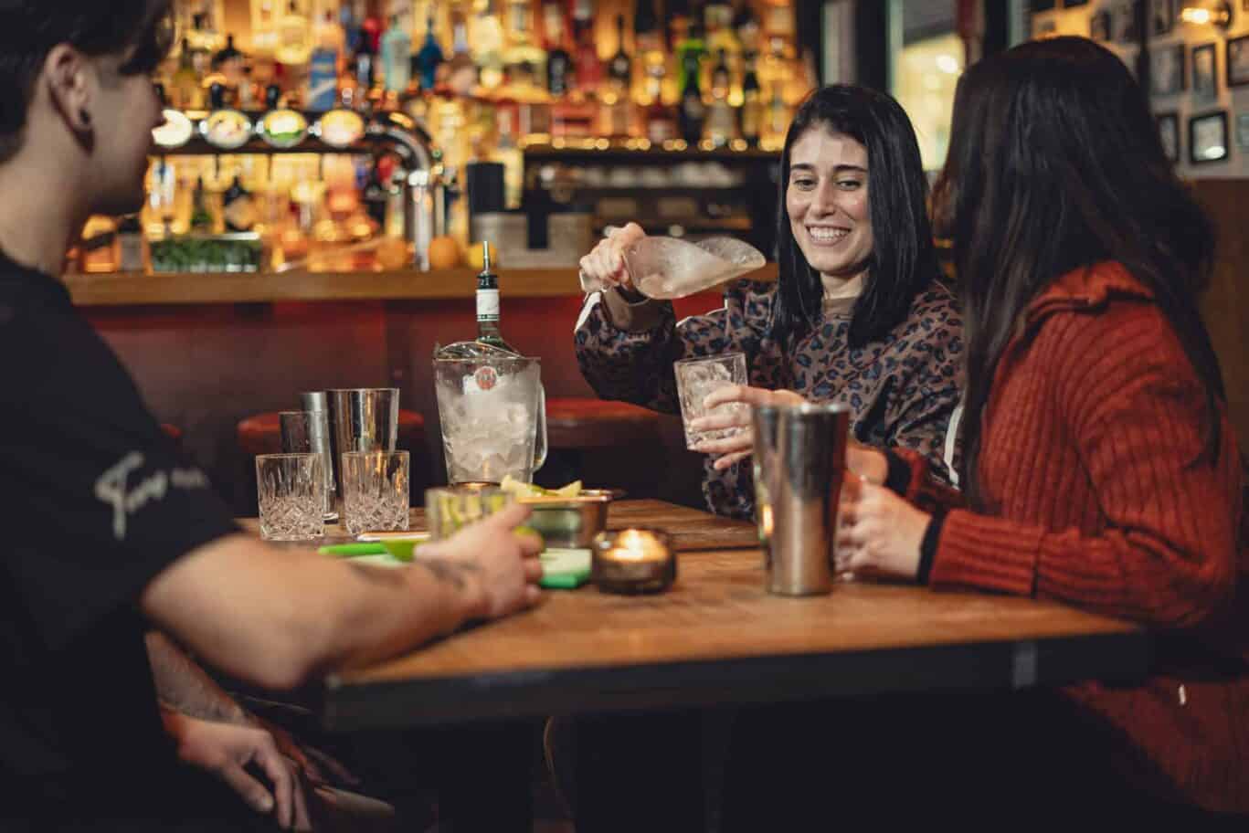 People enjoying drinks at a bar in Paris.