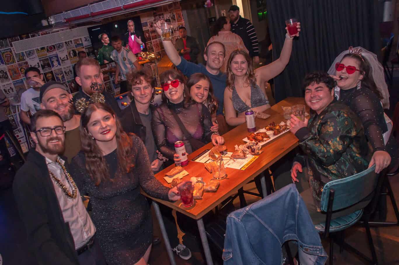 Group of friends enjoying drinks and socialising at Las Ramblas Hostel, Barcelona.