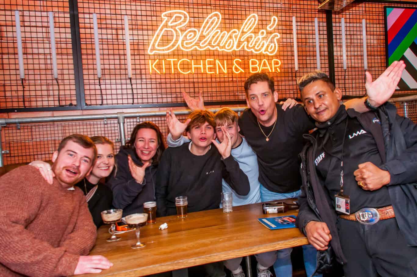 Group of young people enjoying drinks at Belushi's Kitchen & Bar in Barcelona.