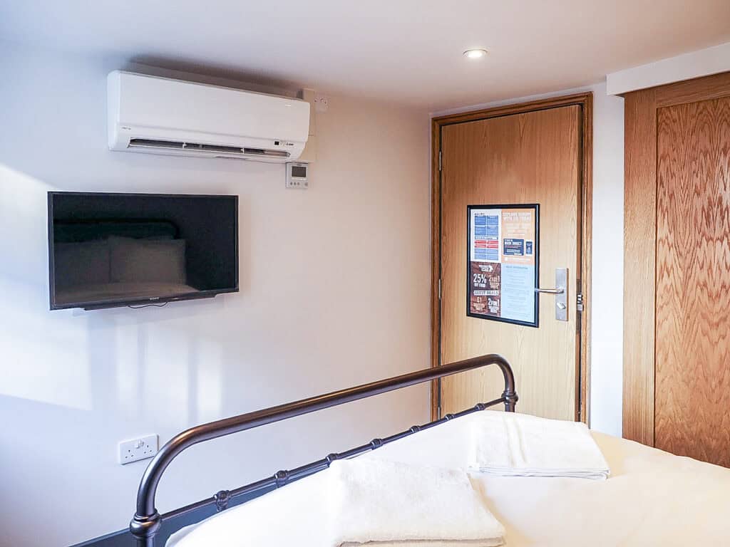 Modern hostel room at St Christopher’s Liverpool Street with comfortable bed and amenities.