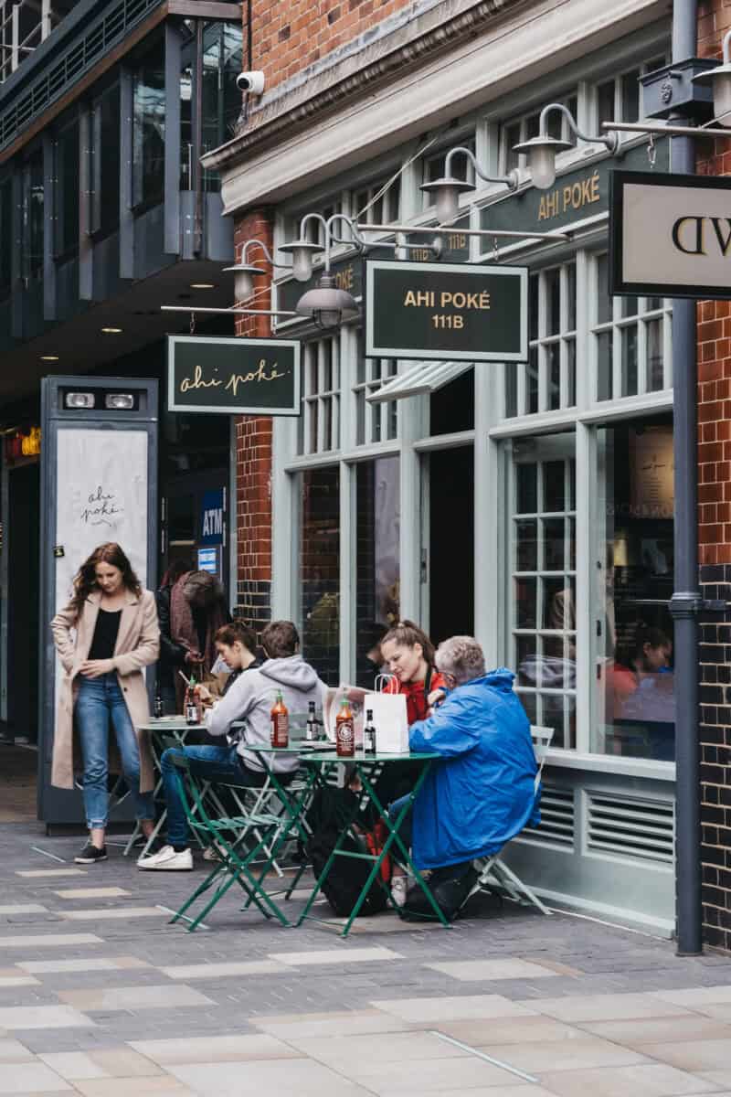 Outdoor dining scene at St Christopher's Liverpool Street hostel in London.