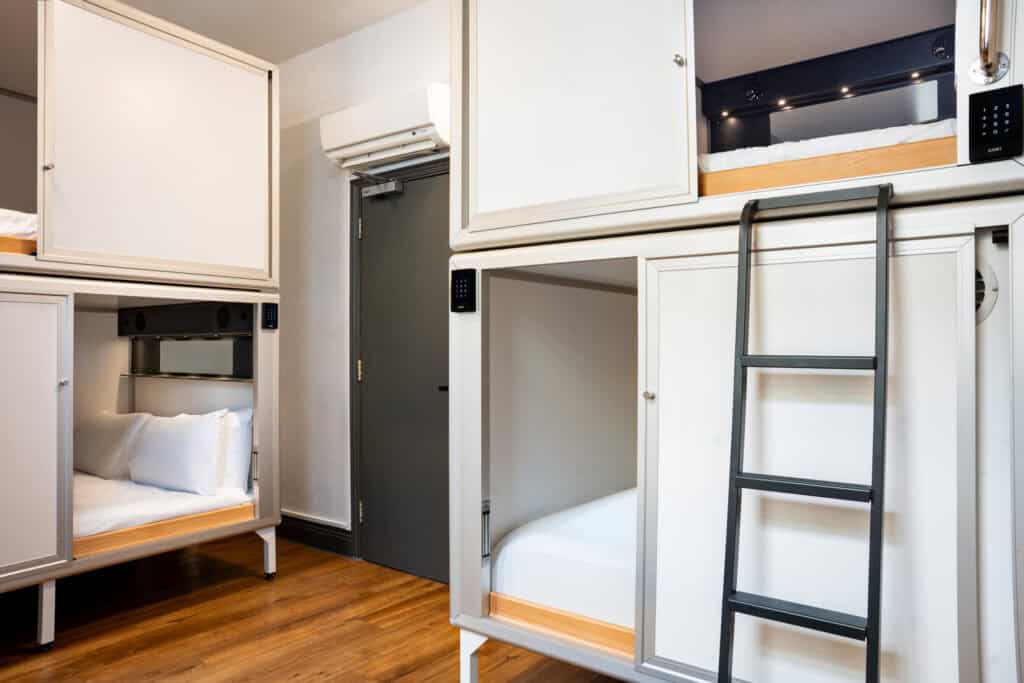 Interior view of bunk beds and sleeping pods at St Christopher’s London Bridge hostel.