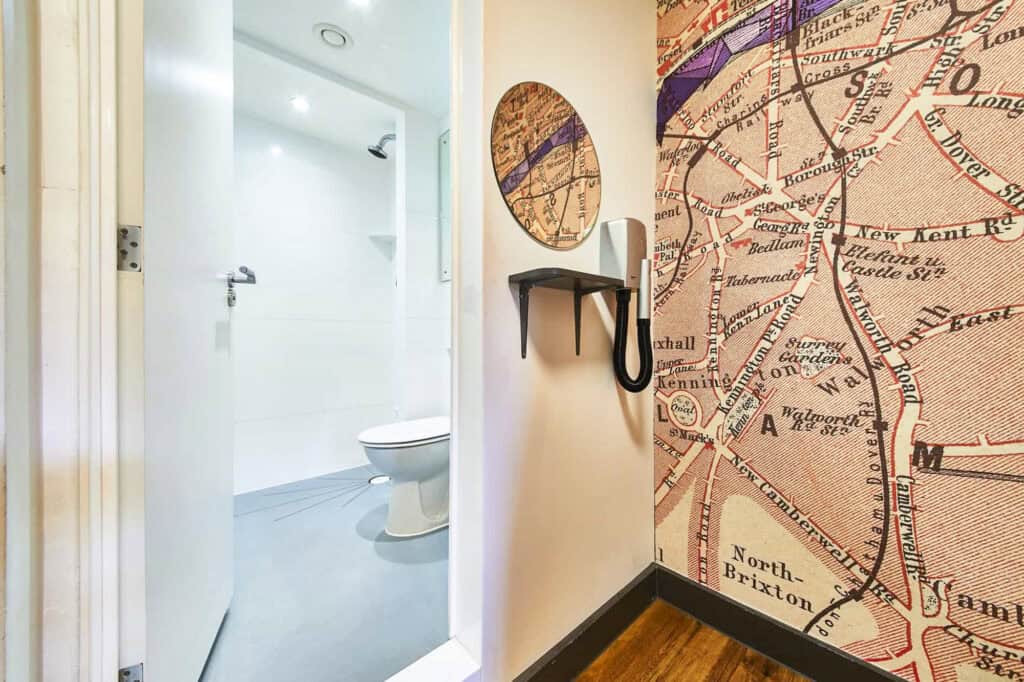 Modern hostel bathroom with white fixtures and clean design.