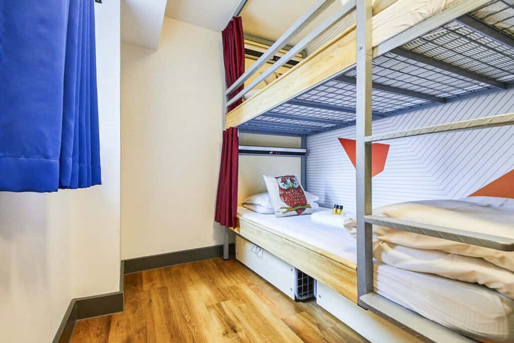 Modern bunk bed room at St Christopher’s London Bridge Hostel with colourful decor.