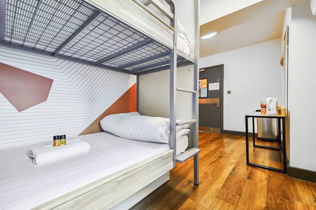 Modern hostel room with bunk beds and wooden flooring at London Bridge.