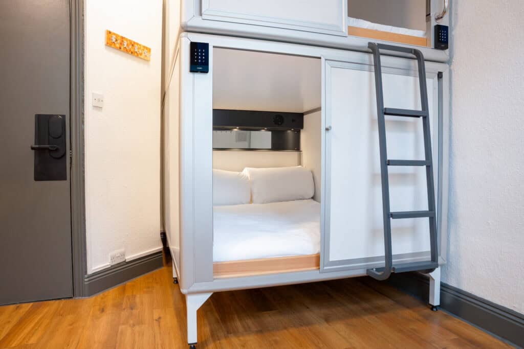 Bunk bed with built-in workspace and storage at St Christopher’s London Bridge hostel.
