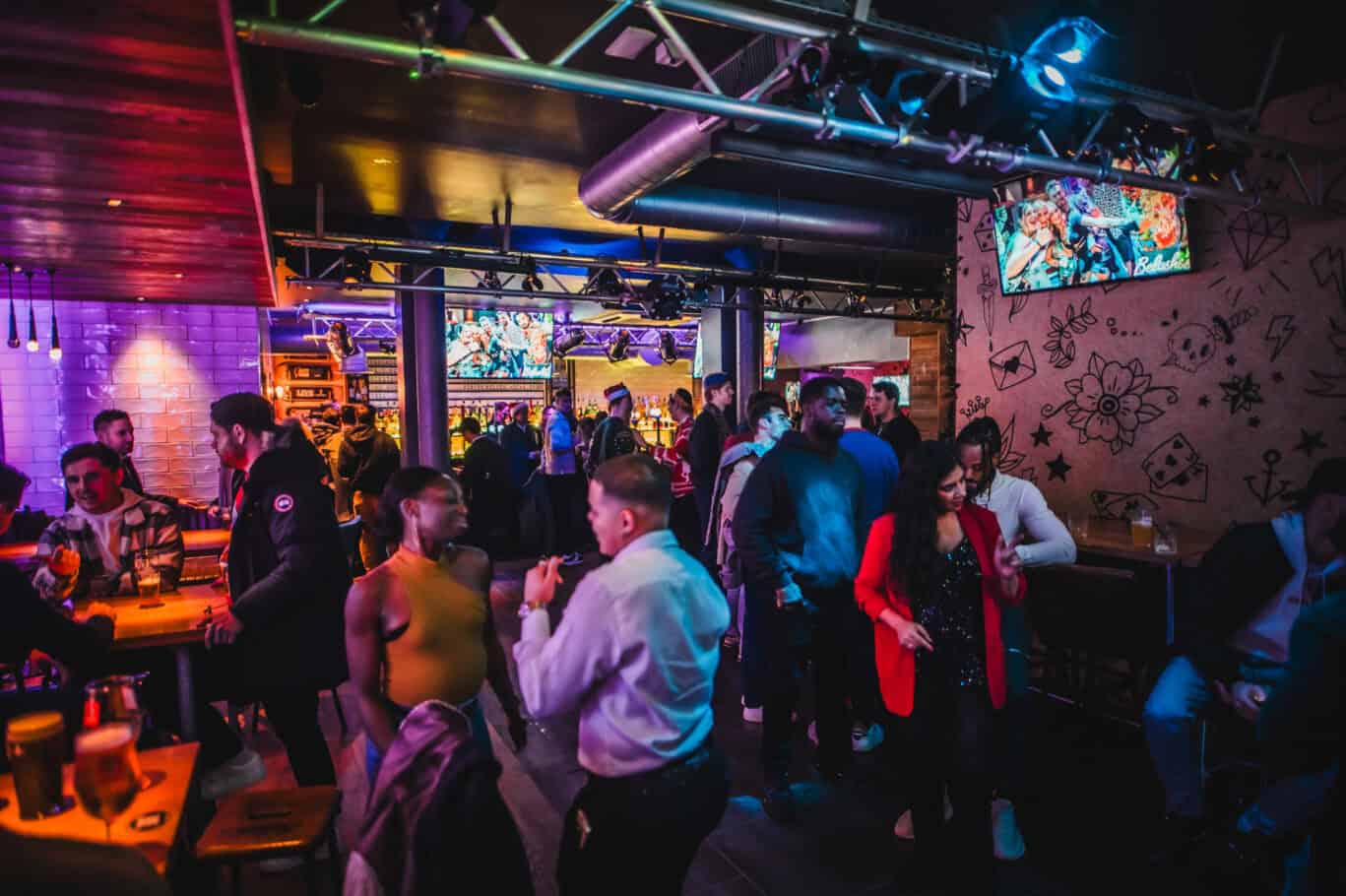 Nightlife at St Christopher’s London Bridge Hostel with guests socialising and enjoying drinks.