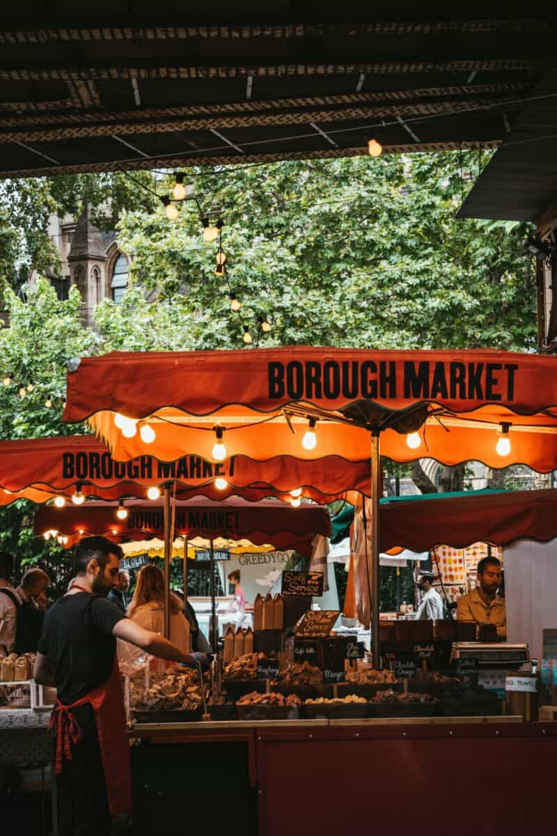 View of Borough Market at London Bridge with food stalls and visitors, near St Christopher's Inns.