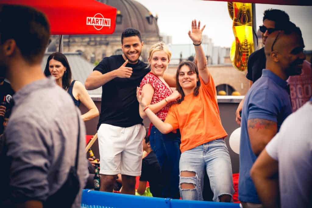 Vibrant social scene at St Christopher's Berlin Mitte hostel with travellers enjoying drinks and fun.