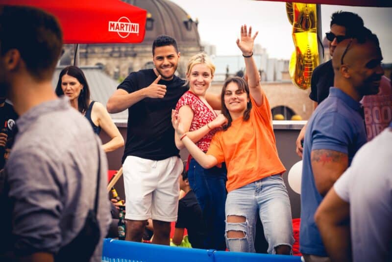 Vibrant social scene at St Christopher's Berlin Mitte hostel with travellers enjoying drinks and fun.