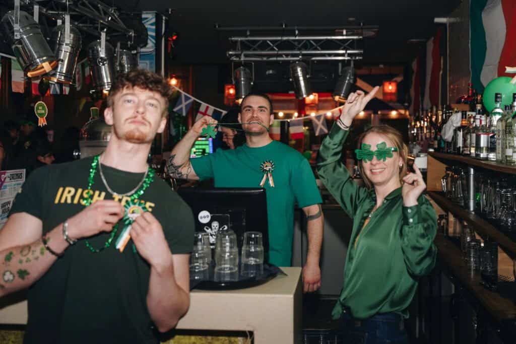 Vibrant social scene at Mitte Hostel Berlin with guests enjoying drinks and celebrations.