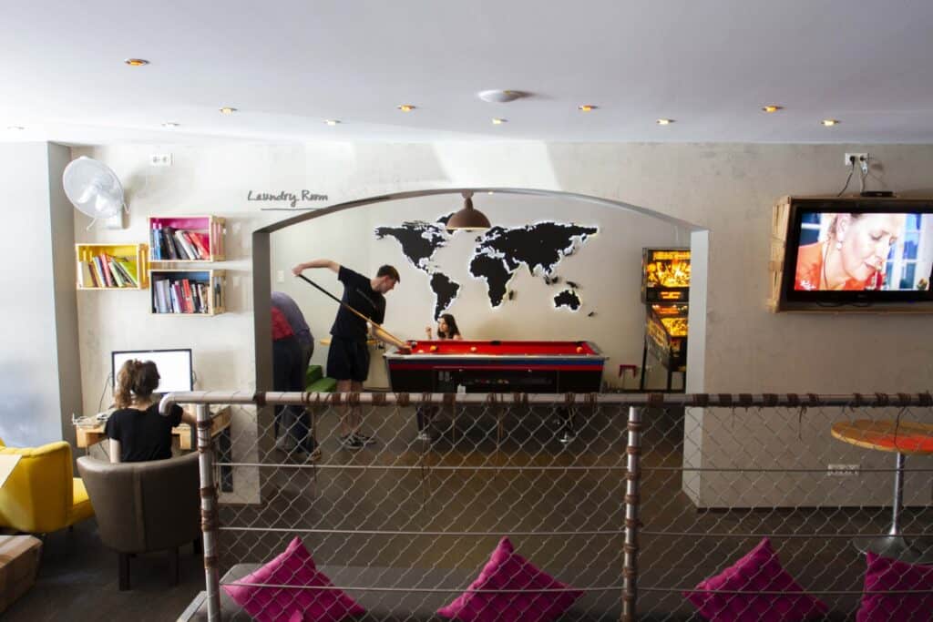 Modern hostel lounge with world map wall art and communal area in Berlin Mitte.