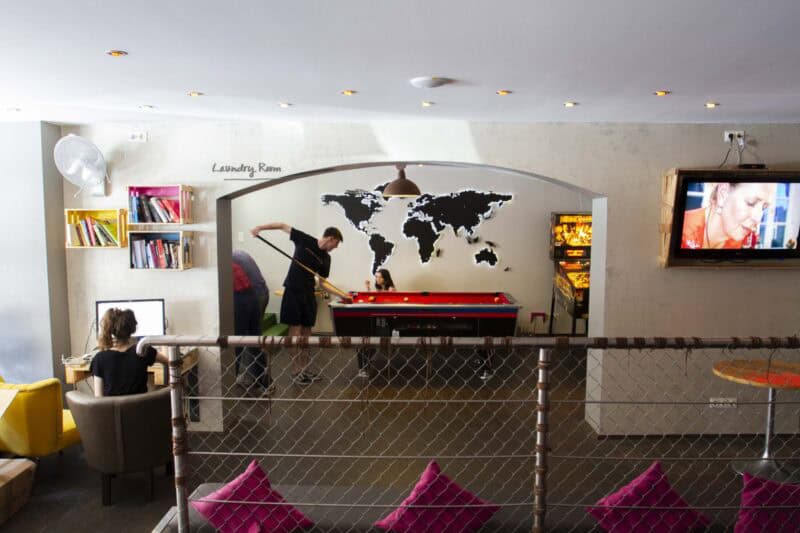 Modern hostel lounge with world map wall art and communal area in Berlin Mitte.