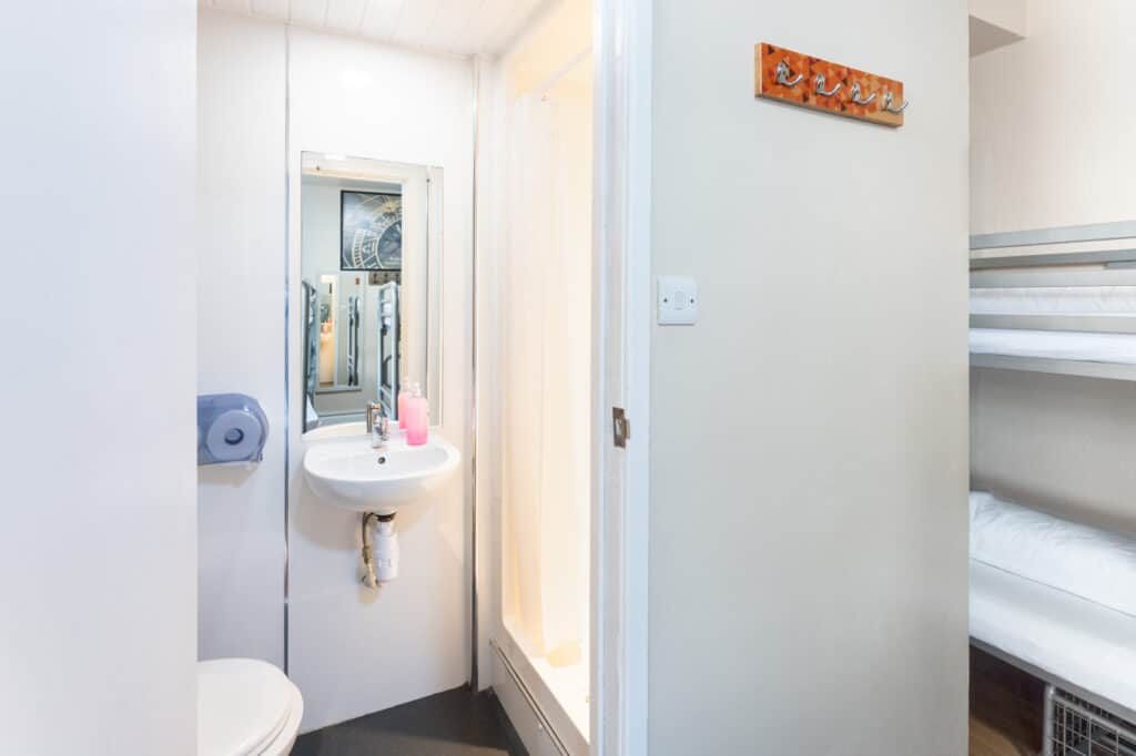 Modern hostel bathroom at St Christopher’s Newquay with clean facilities and simple decor.