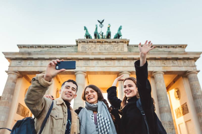 Travelers taking a selfie in front of the Brandenburg Gate at St Christopher's Berlin Mitte.