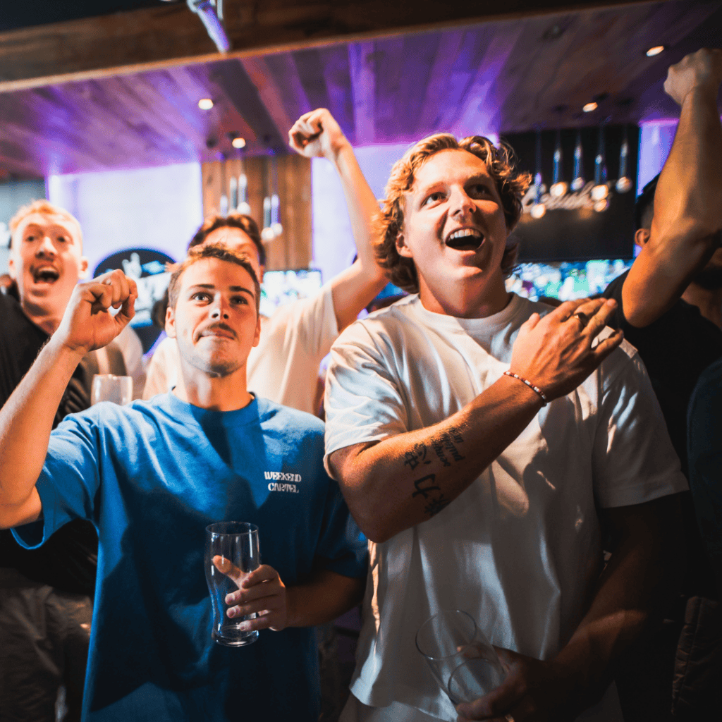 Group of young people celebrating at a lively bar in Edinburgh.