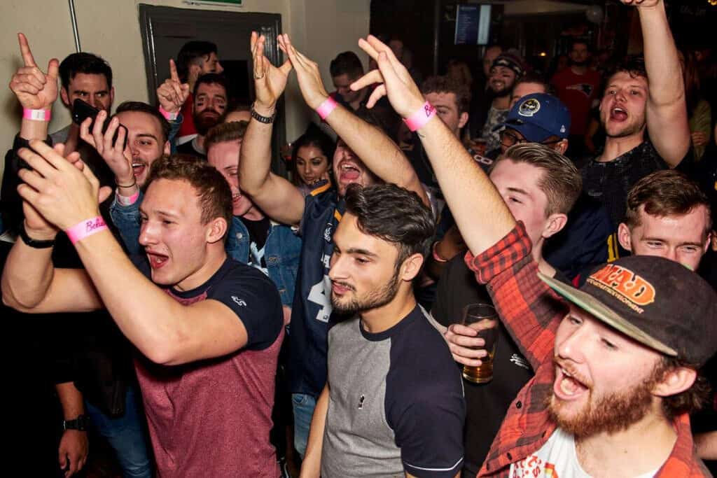 Vibrant group of young people enjoying a lively night at St Christopher’s Edinburgh hostel.