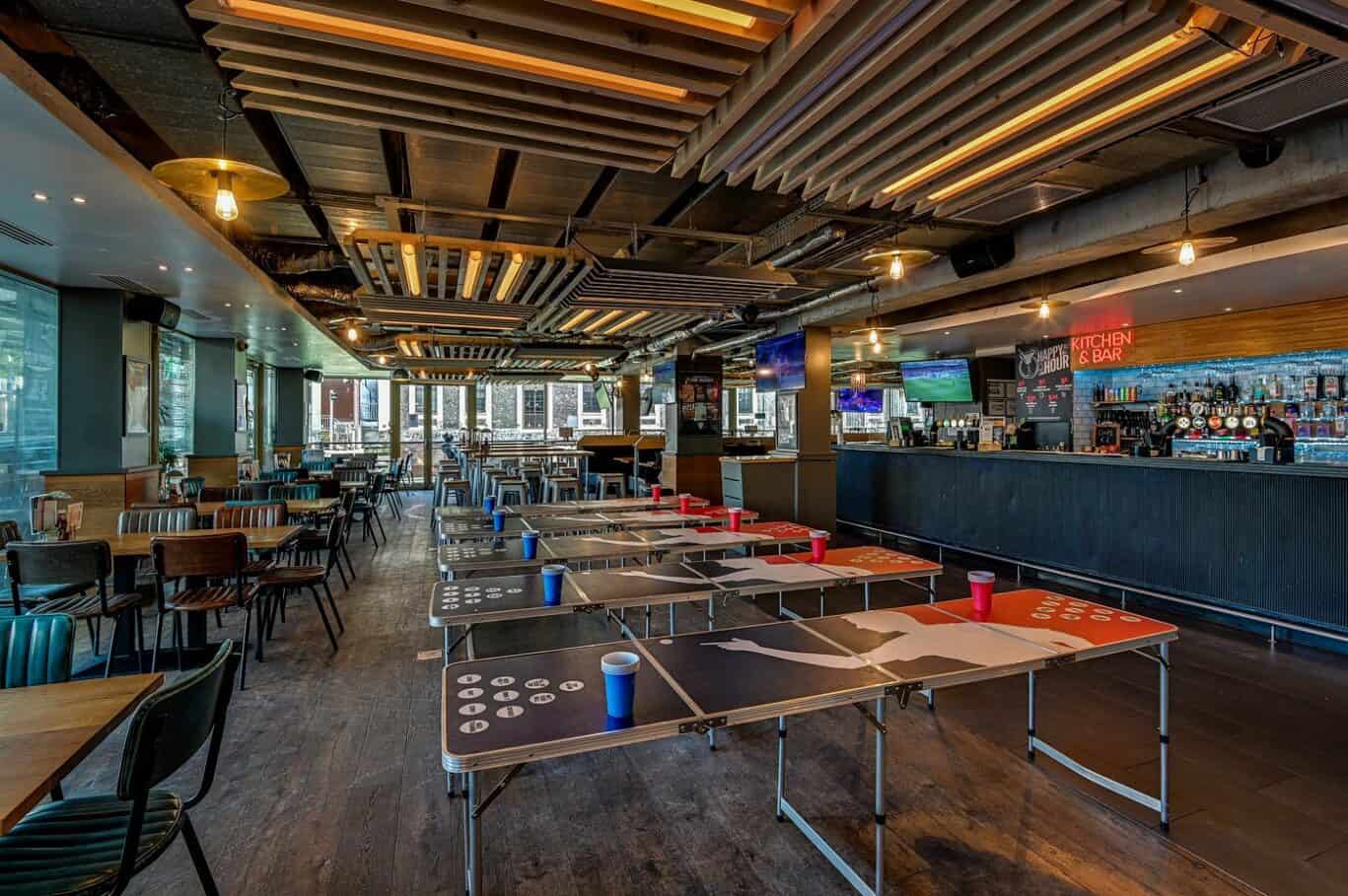 Modern bar and lounge area at St Christopher’s Paris - Canal hostel, with ping pong tables and vibra.